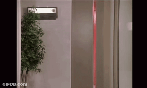 Room With Plant And Elevator Sign GIF