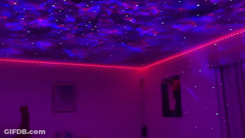 Room With Projector Showing Starry Sky GIF