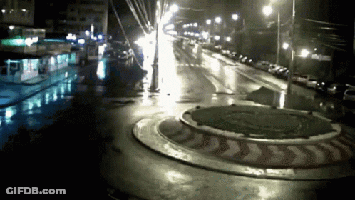 Roundabout At Night With Red And White Arrow GIF