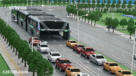 Row Of Cars Driving Down Street With CCTV News Sign GIF