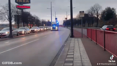 Row Of Cars Driving Past IKEA Sign GIF