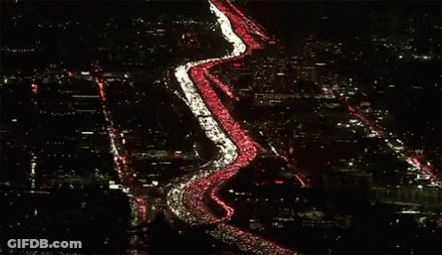 Row Of Cars Lined Up On Road GIF