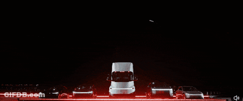Row Of Cars Parked In Dark Area GIF