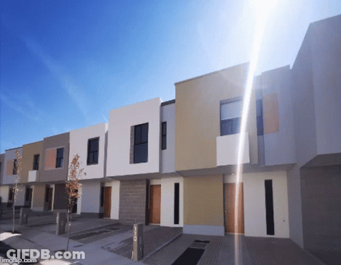 Row Of Houses With Sun Shining Through GIF