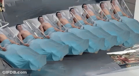 Row Of Men In Hospital Beds With Woman Picture On Floor GIF