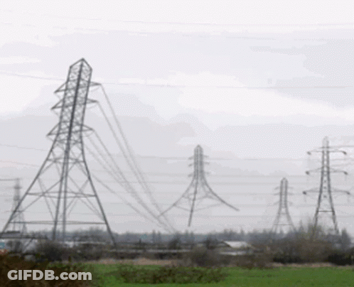 Row Of Power Lines Through A Field GIF