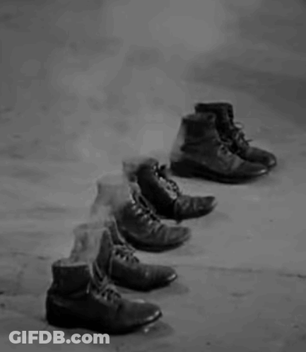 Row Of Shoes On Concrete Floor GIF