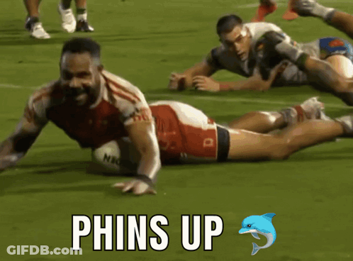 Rugby Player Laying Down With Phins Up GIF