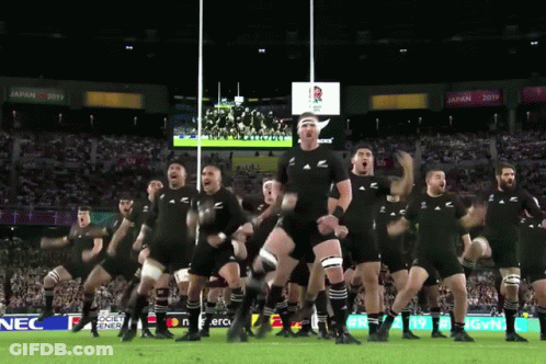 Rugby Players Performing Haka With Nec Sign GIF