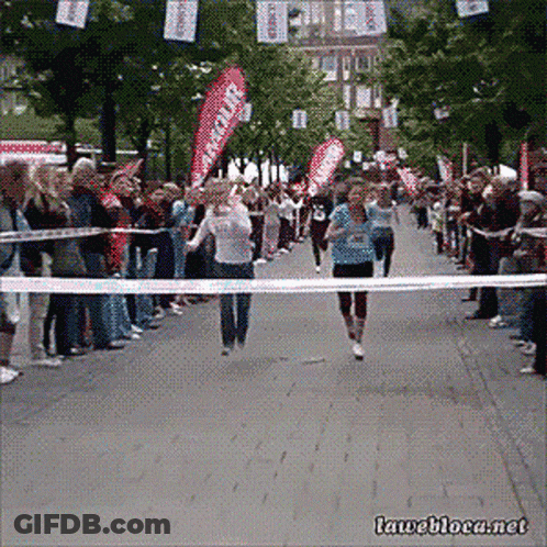 Runner Crossing Finish Line With Rescue Banner GIF