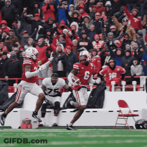 Running High Five Huskers Players GIF