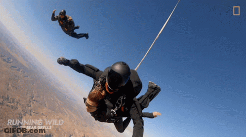 Running Wild Bear Grylls Two People Parachuting GIF