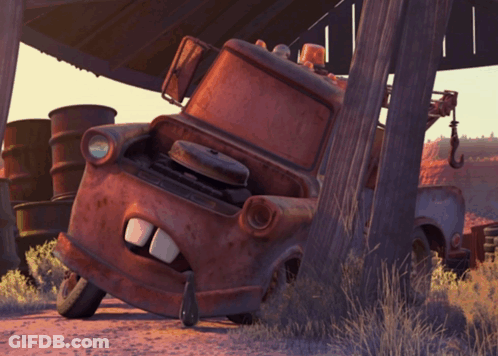 Rusty Tow Truck Leaning Against Wooden Post GIF