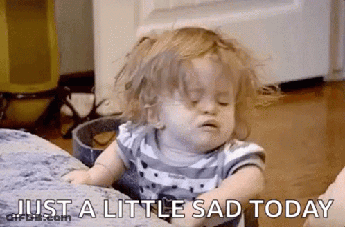 Sad Baby Girl Sitting On Couch Eyes Closed GIF