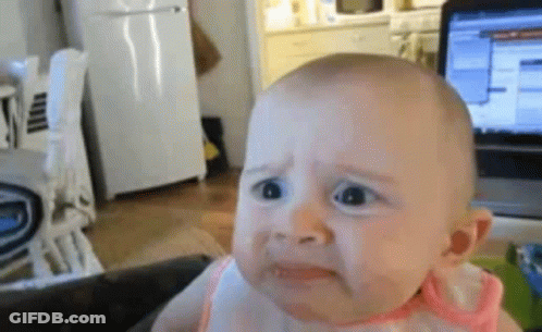 Sad Baby Sitting In Front Of Laptop GIF