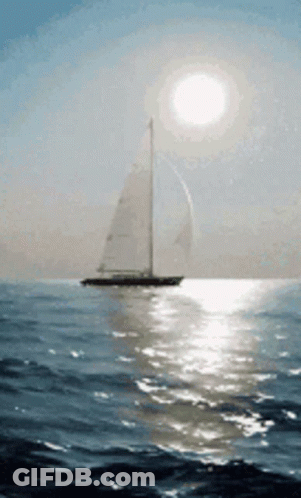 Sailboat In Ocean With Bright Sun GIF