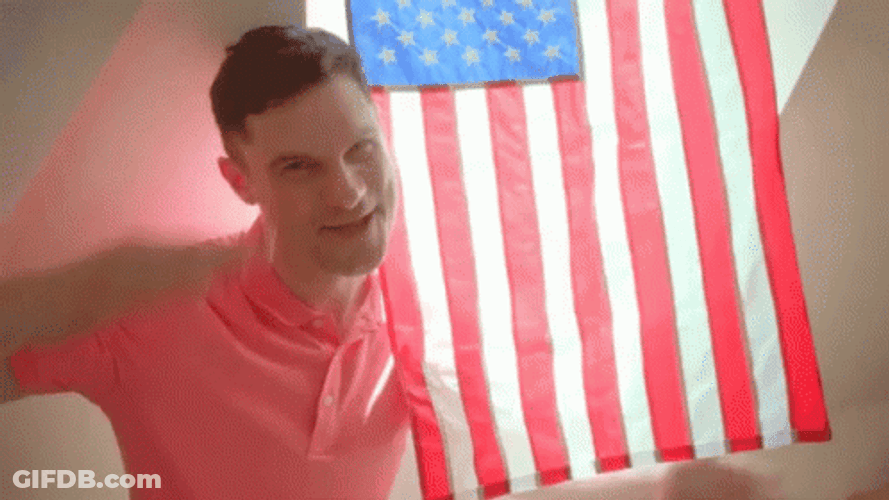 Saluting And Holding American Flag Waving GIF