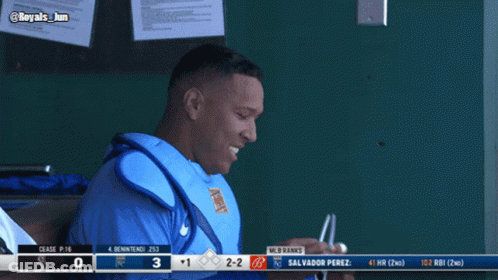 Salvador Perez Is Sitting In The Dugout During A Baseball Game Against The Royals GIF