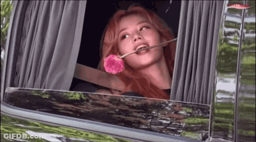 Sana Adorably Biting A Pink Rose GIF