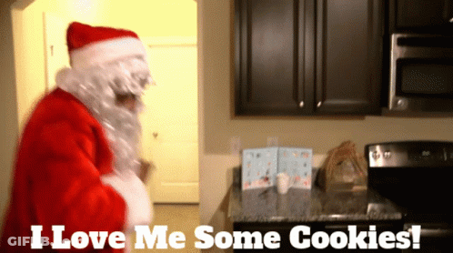 Santa Claus In A Kitchen With The Words " I Love Me Some Cookies " Above Him GIF