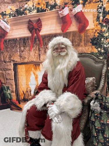 Santa Claus Sitting By Fireplace With Christmas Stockings GIF