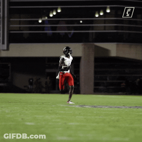 Sauce Gardner Running While Holding Football GIF