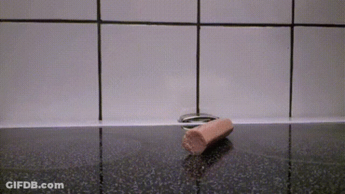 Sausage Laying On Black Counter GIF