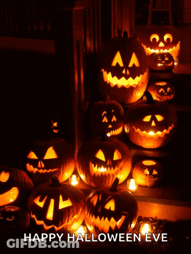 Scarecrow Next To Carved Pumpkin In Dark GIF