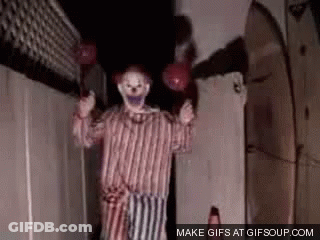 Scary Clown Holding Balloons In Dark Room GIF