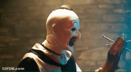Scary Clown Holding Wooden Stick With Nails GIF