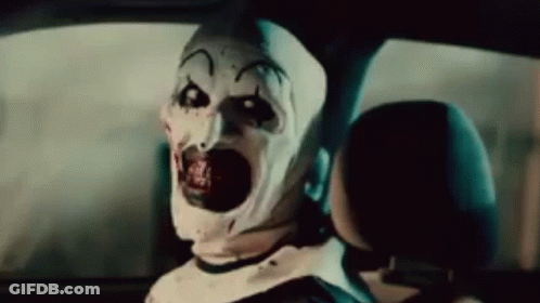 Scary Clown Sitting In Back Seat Of Car With Mouth Open GIF