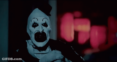 Scary Clown Standing In Dark Room GIF