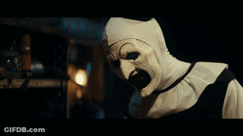 Scary Clown With White Mask Looking At Camera GIF