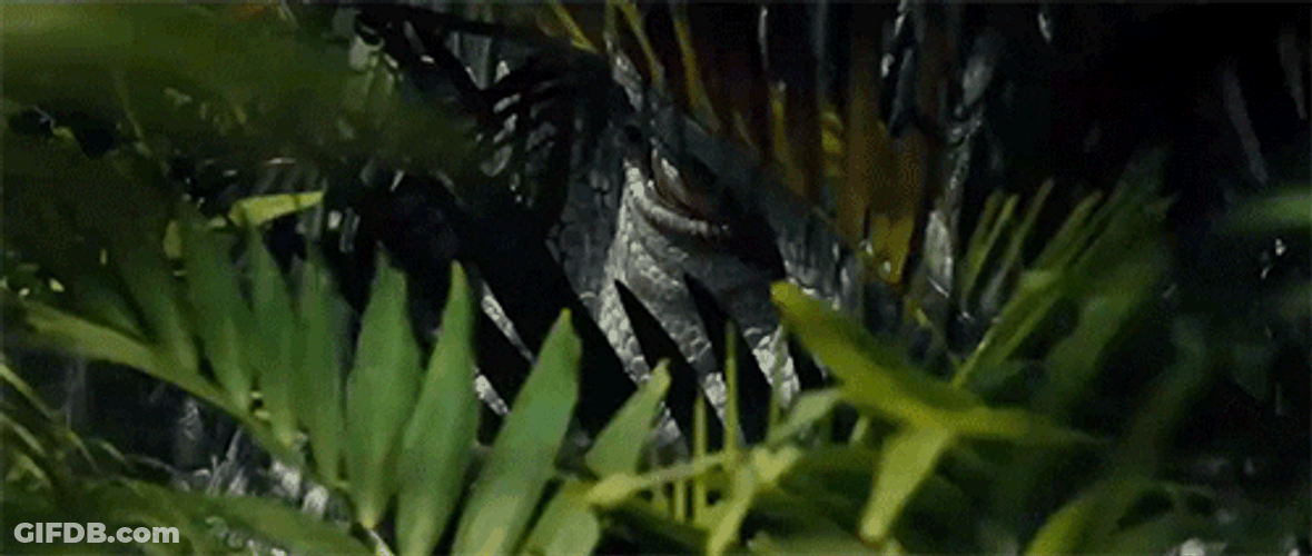 Scary Dinosaur Stalking Behind Bush GIF