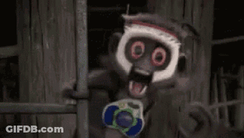 Scary Monkey Holding Toy Gun In Dark Room GIF