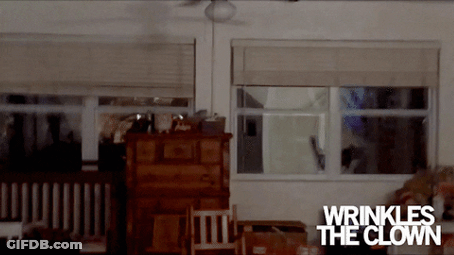 Scary Movie Clown Standing In The Window GIF