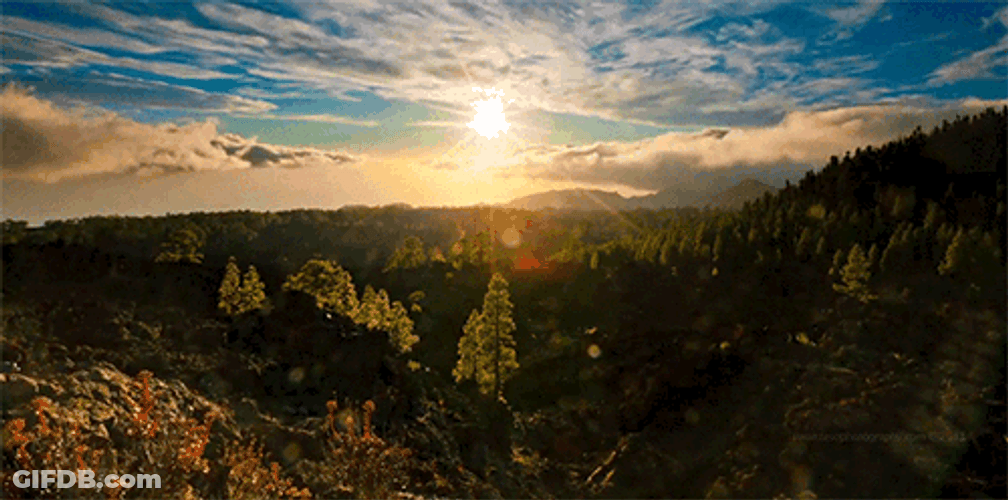 Scenic Blue Sky Moving Clouds Above Mountains GIF