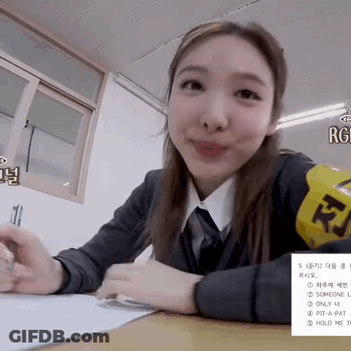 Schoolgirl At Desk With Yellow RJ Armband GIF