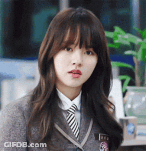 Schoolgirl With Striped Tie Looking At Camera GIF