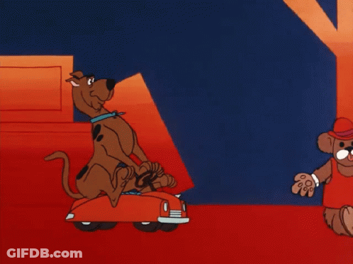 Scooby Doo Is Carrying A Stack Of Boxes In A Red Car GIF