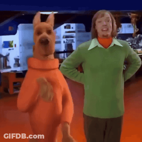 Scooby Doo Next To Man In Green Sweater GIF
