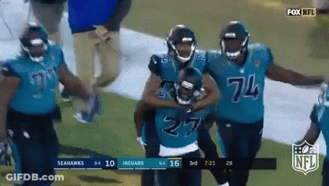 Seahawks And Jaguars Players Walking On Field GIF