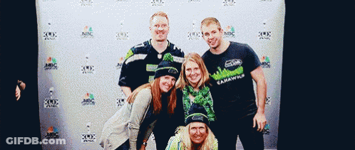 Seahawks Fans Posing In Front Of Wall GIF