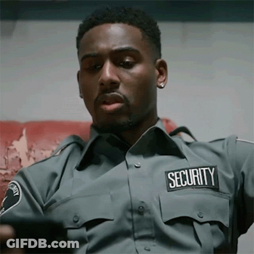 Security Man Looking At Cell Phone GIF