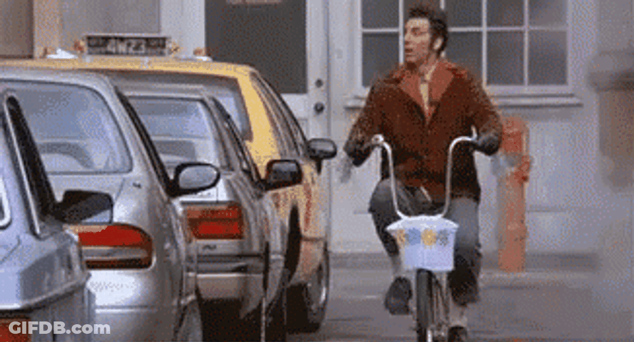 Seinfeld Kramer Giddy Up Salute While Riding Bike GIF