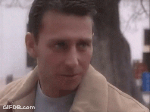 Serious Man In Tan Jacket And Blue Shirt GIF