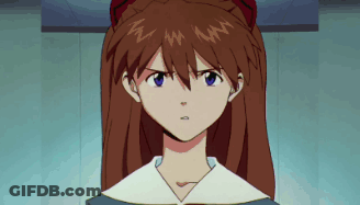 Serious Redhead Girl With Blue Eyes Looking At Camera GIF
