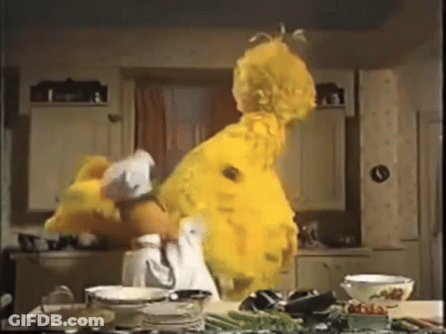 Sesame Street Big Bird Is Dancing In A Kitchen With Plates And Bowls GIF