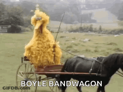 Sesame Street Big Bird Is Riding A Horse Drawn Carriage In A Field . GIF