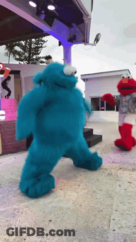 Sesame Street Characters Cookie Monster And Elmo Are Dancing GIF